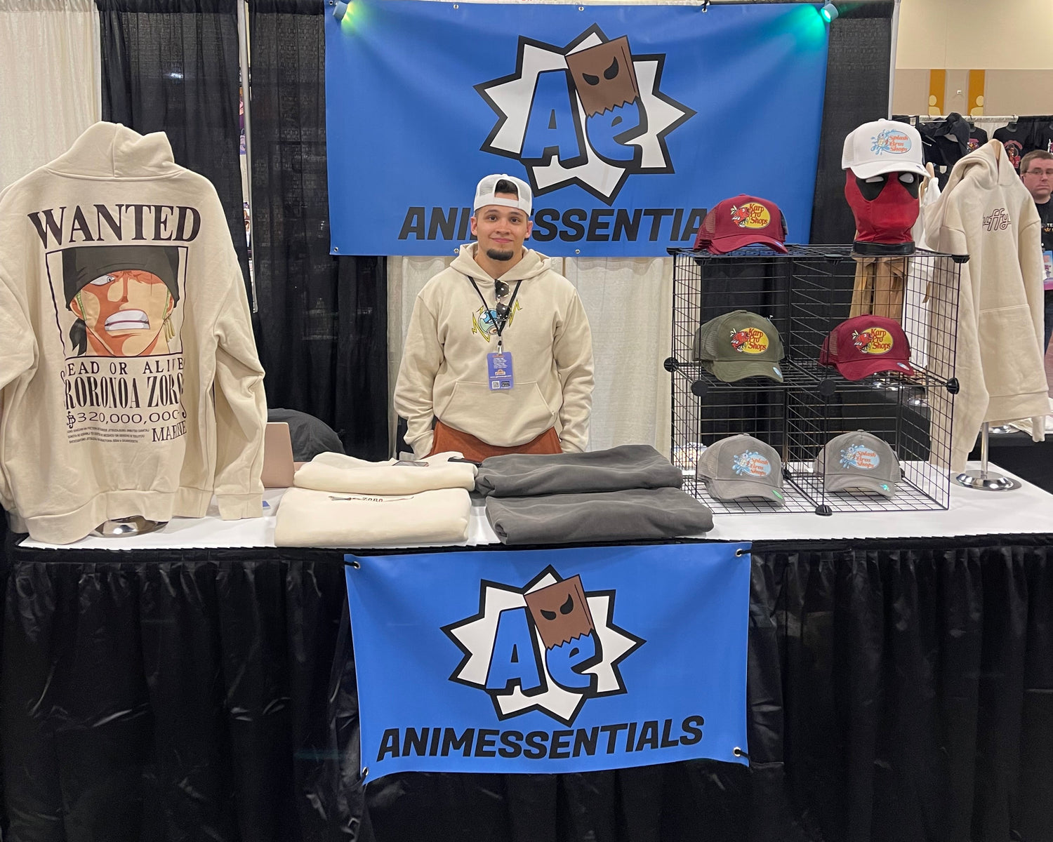 Person wearing a hoodie with a visible brand logo in an indoor settin, Anime, Anime essentials, Anime hoodies, Anime events, Comic con